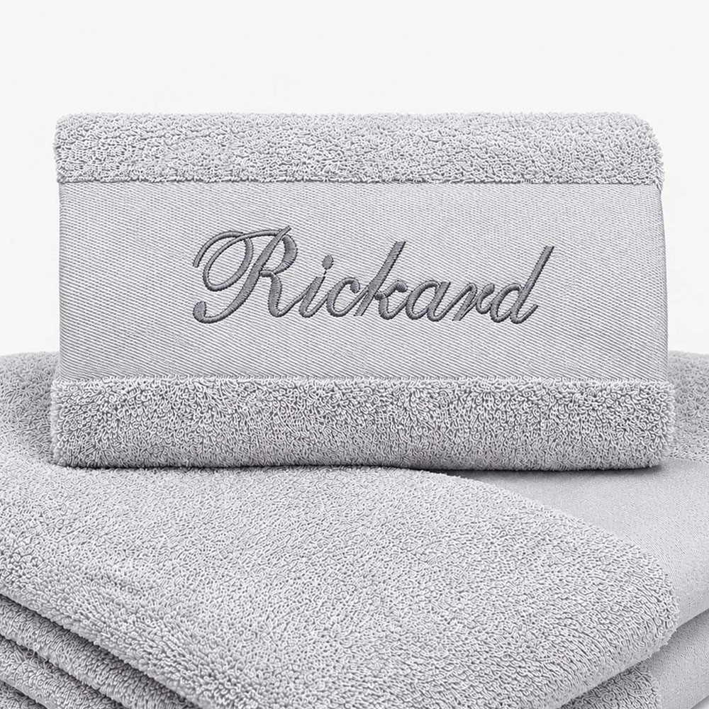 Gray towel with name and black text
