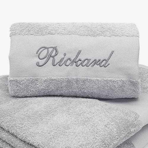 Gray towel with name and black text