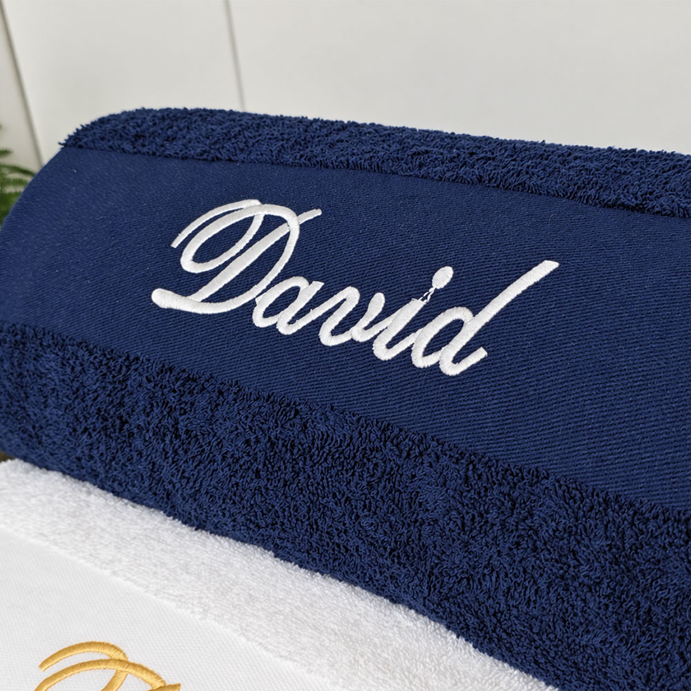 Navy blue personalized towel in use in the bathroom
