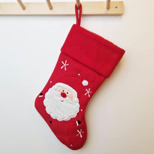 Solid red Christmas stocking with Santa