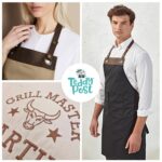Close-up of the front pockets and leather trim on an embroidered chef apron