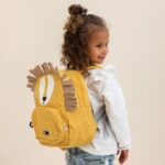 Girl with lion-themed yellow backpack.